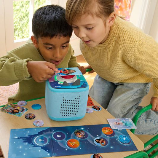 Two children playing with a toy on a table