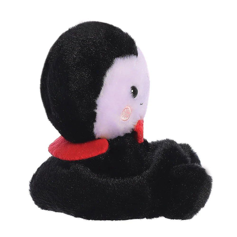 Plush toy penguin with a red scarf on a white background