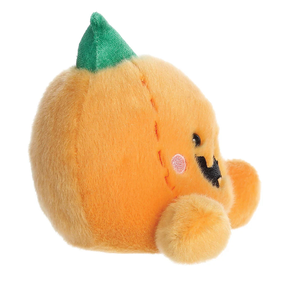 Plush toy resembling a pumpkin with a green leaf on a white background