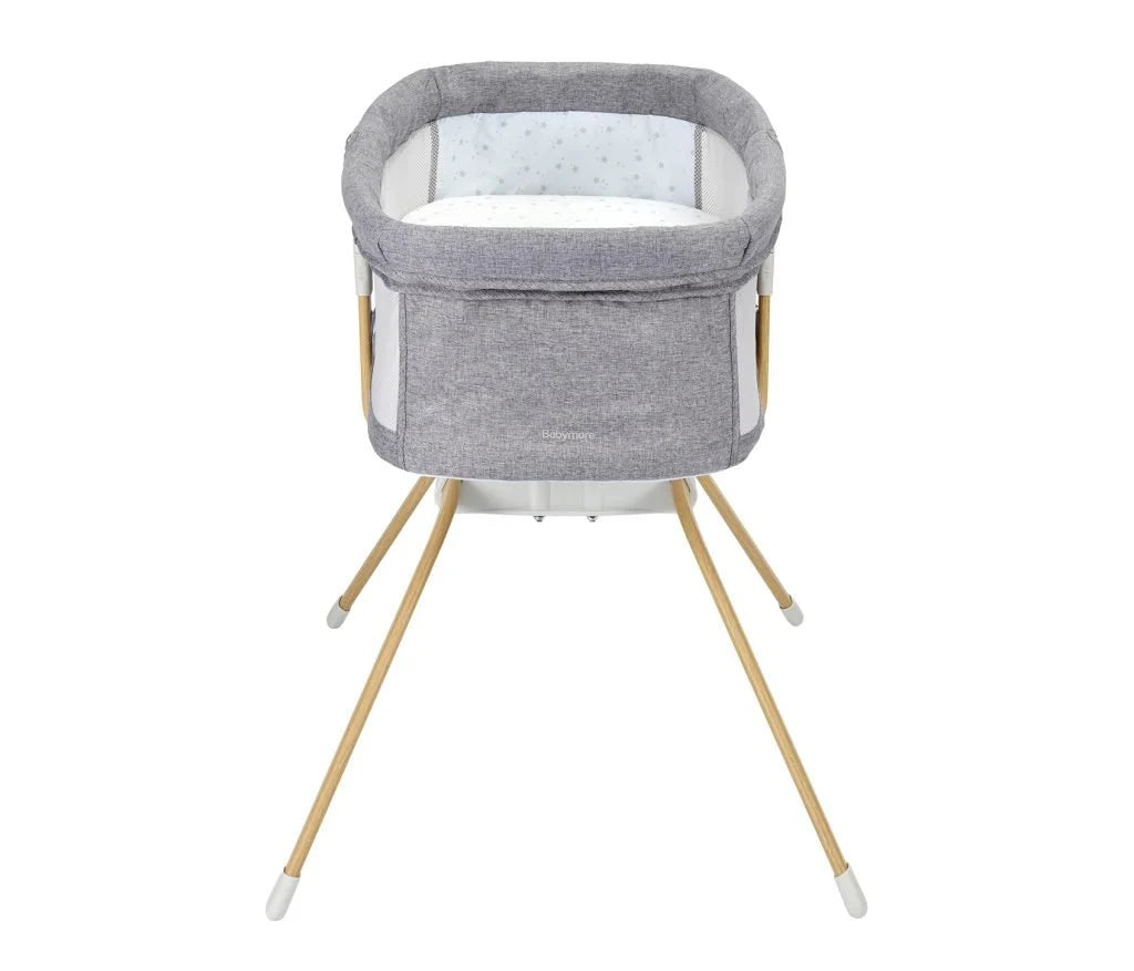 Gray baby bassinet with wooden legs on a white background