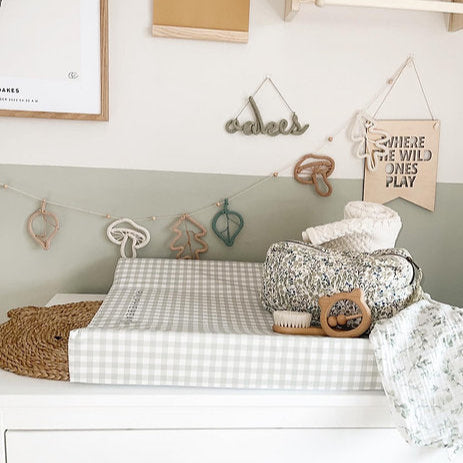 Nursery with a changing table, decorative elements, and wall art.