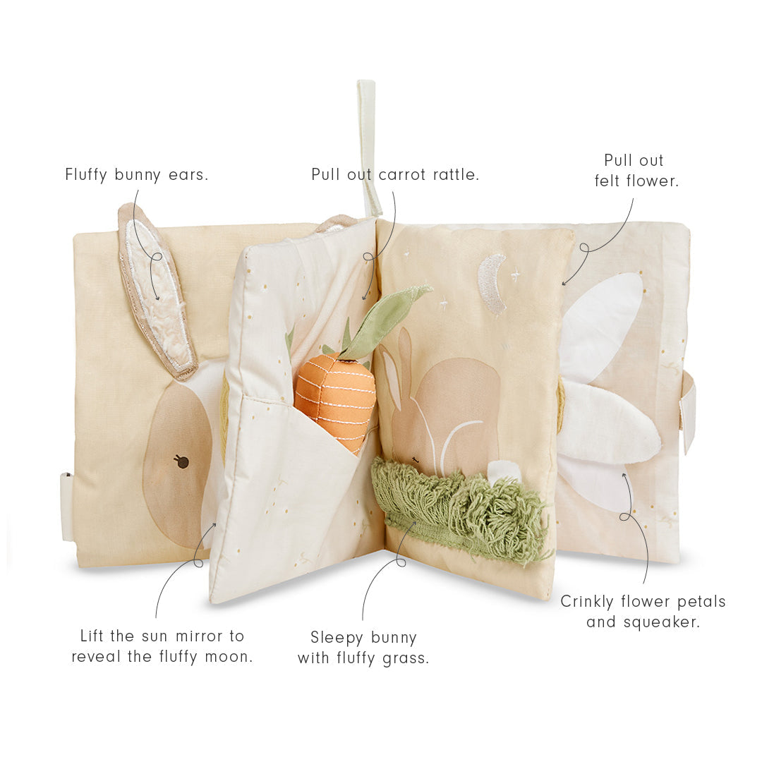 Children's soft book with interactive elements on a white background