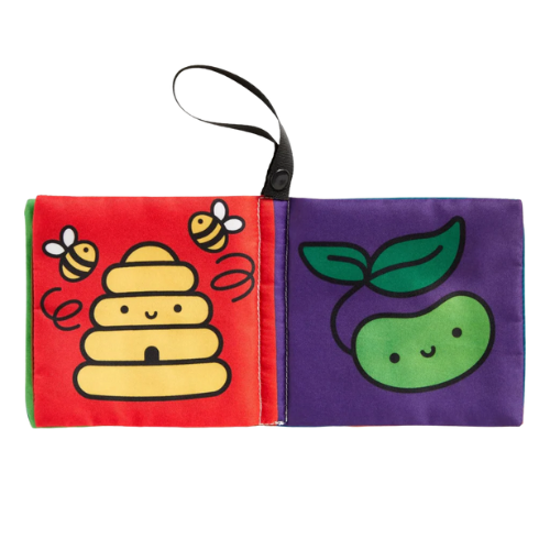 Children's soft book with bee, beehive, and apple illustrations on a white background