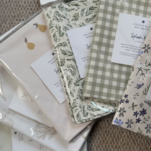 Collection of patterned paper packages with labels on a textured surface