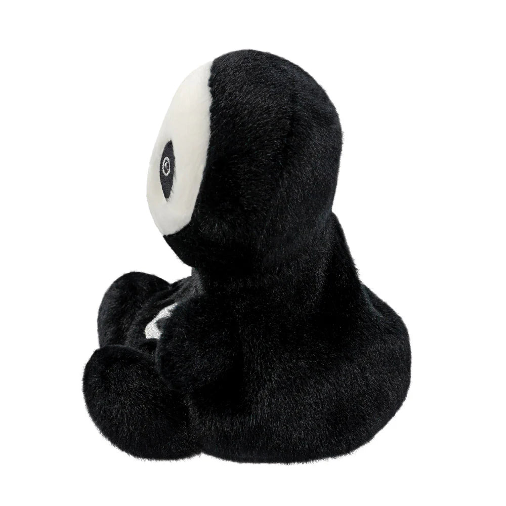 Black plush toy with white face on a white background