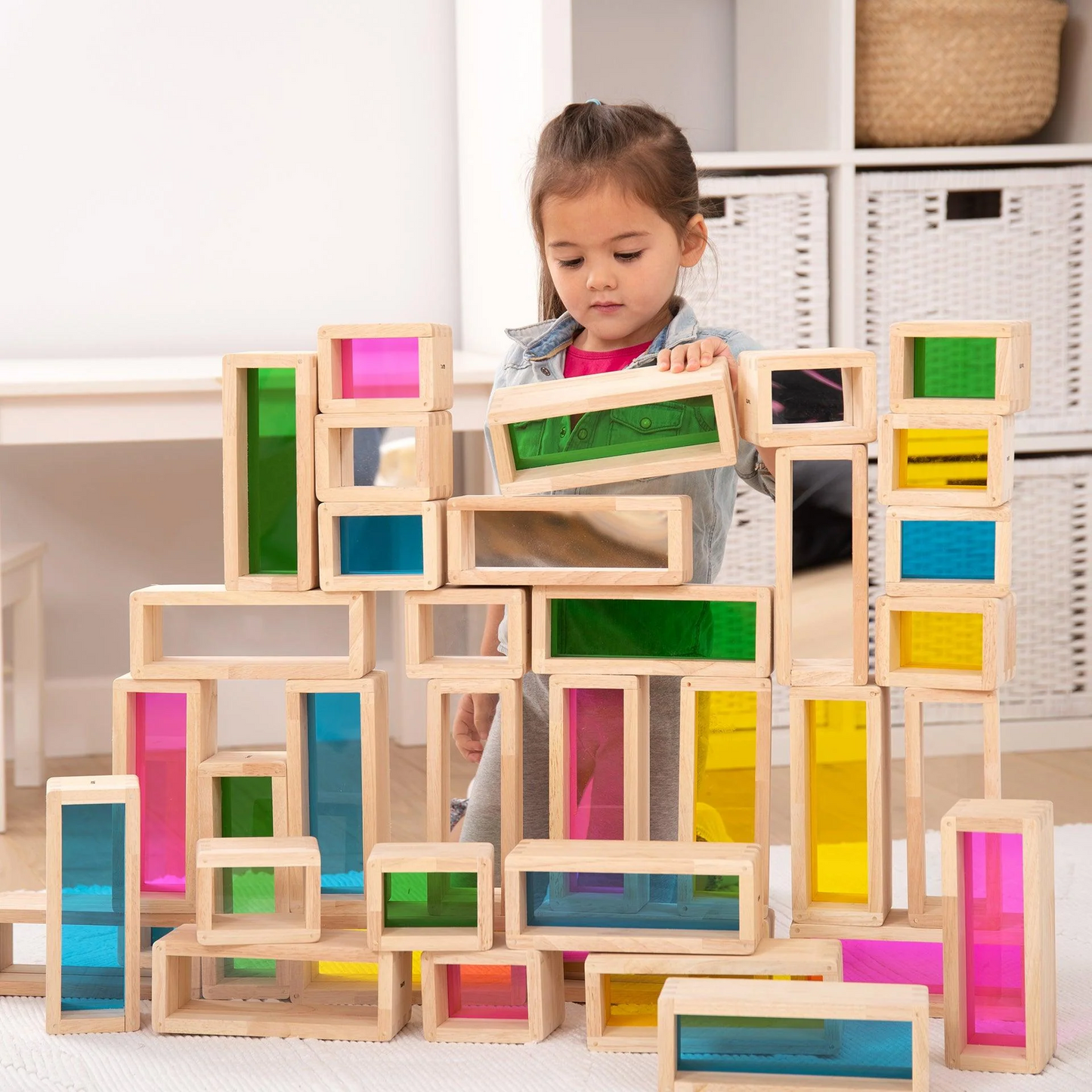 Child playing with colourful wooden blocks in a bright room