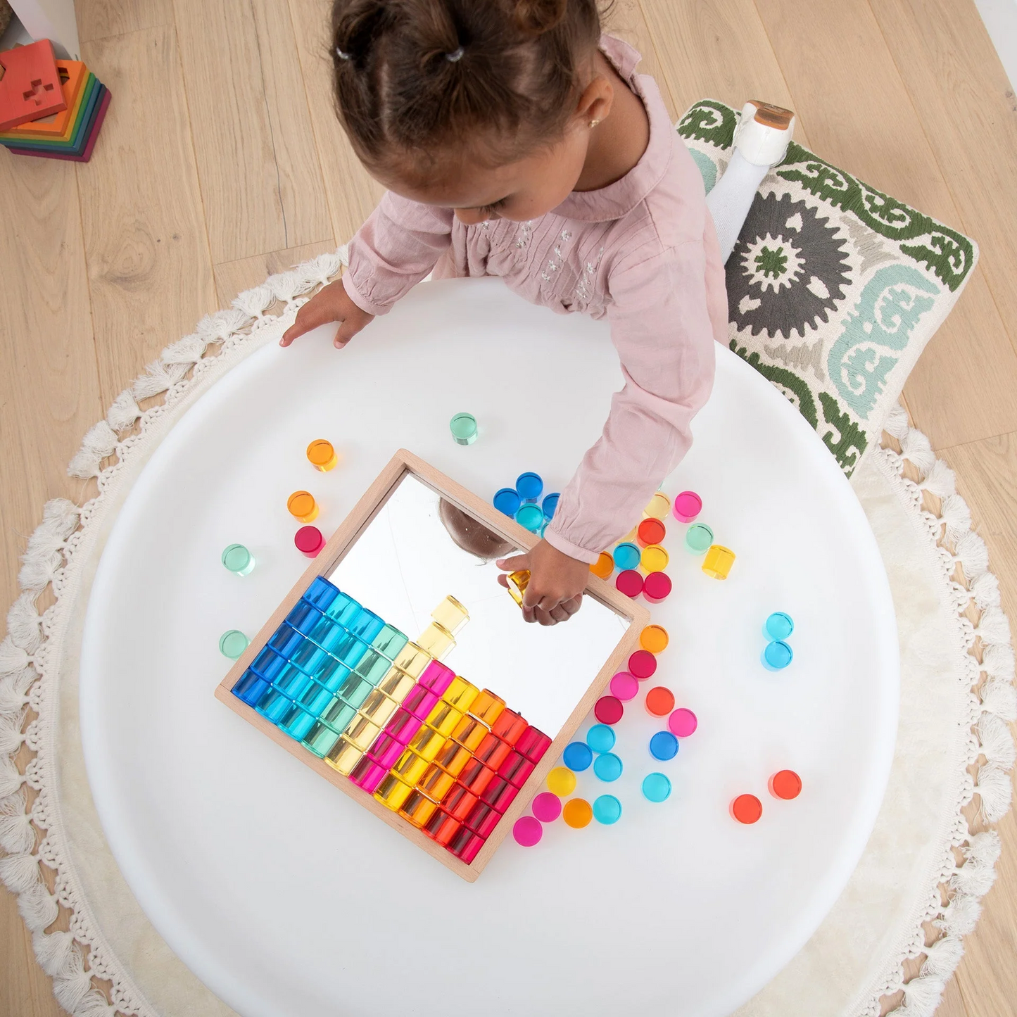 Child playing with acrylic circle blocks