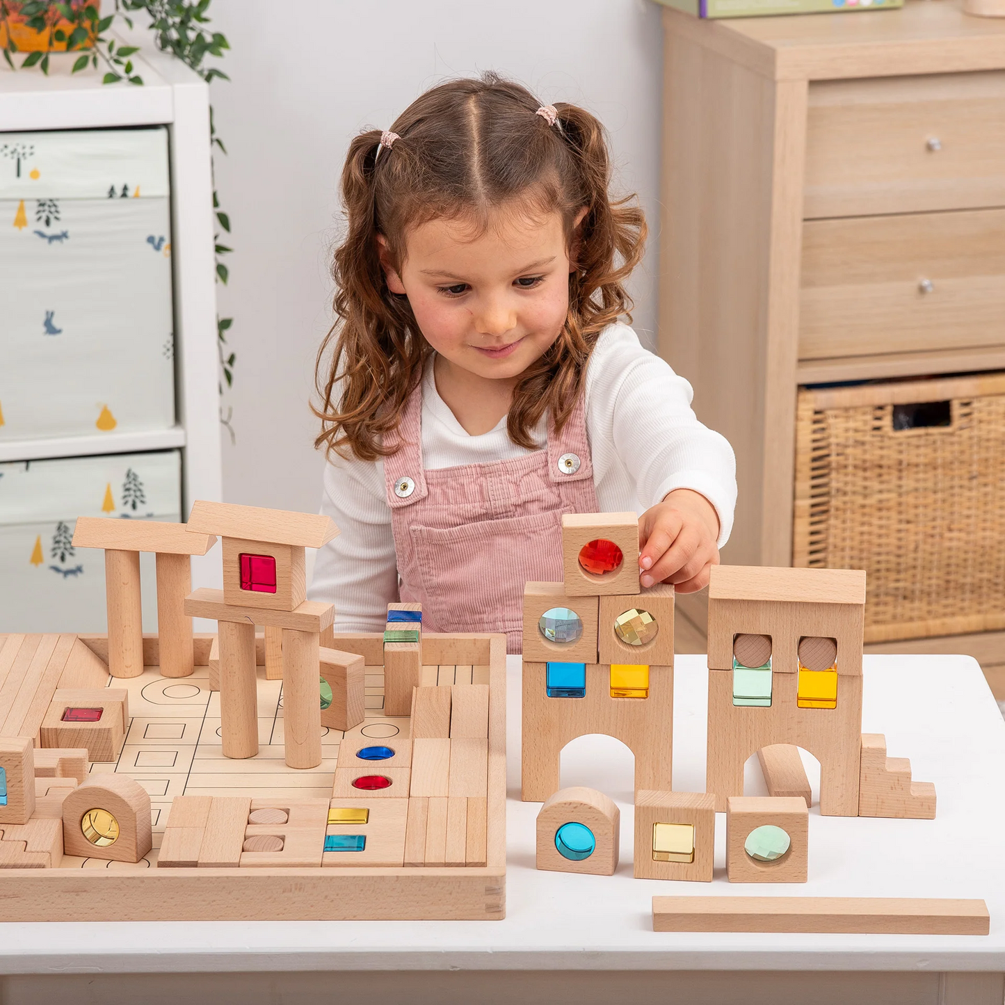 Child playing with wooden building blocks on a table