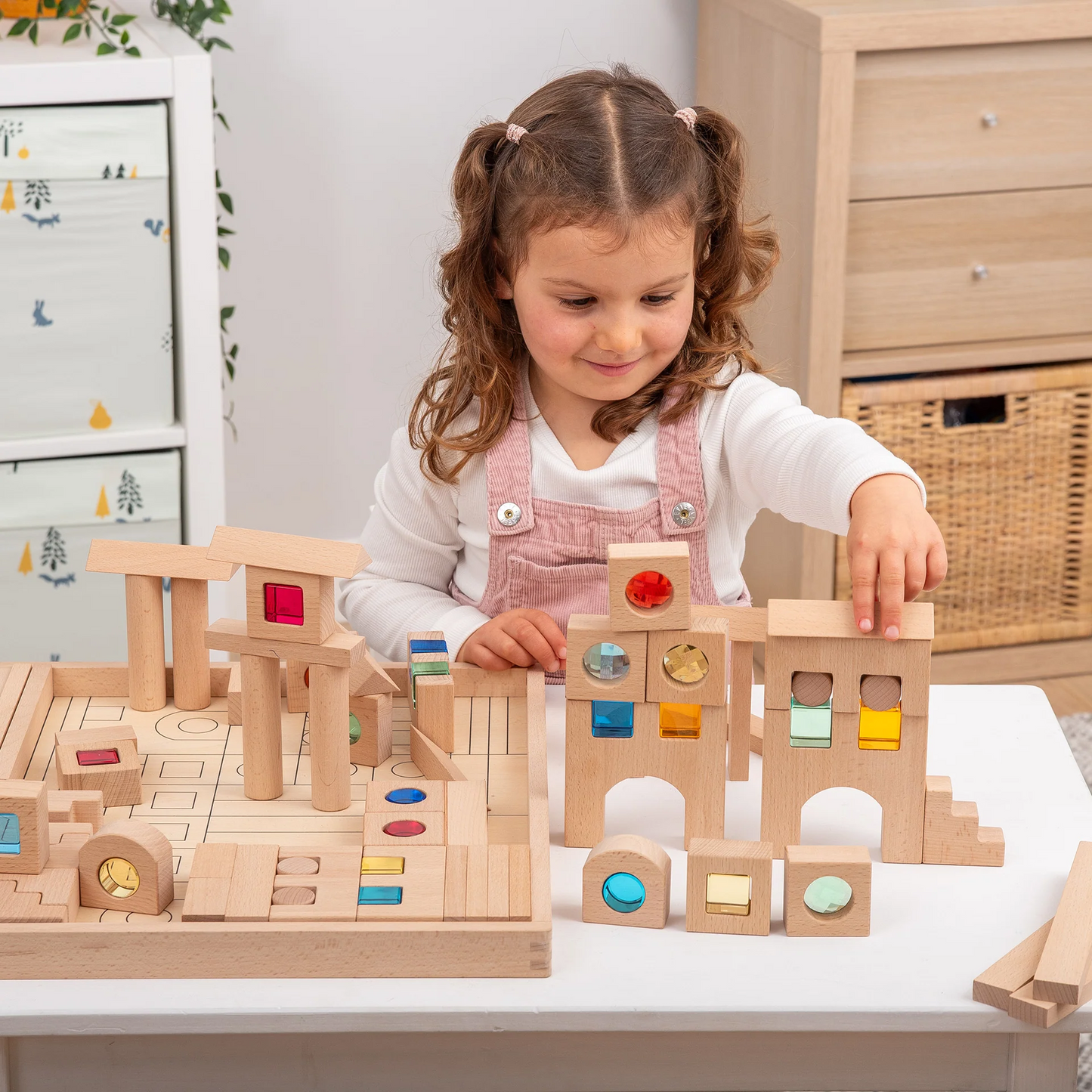 Child playing with wooden building blocks on a table