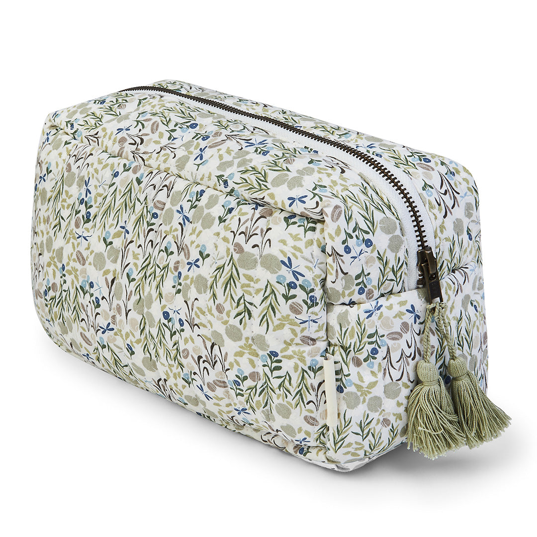 Floral patterned toiletry bag with tassels on a white background