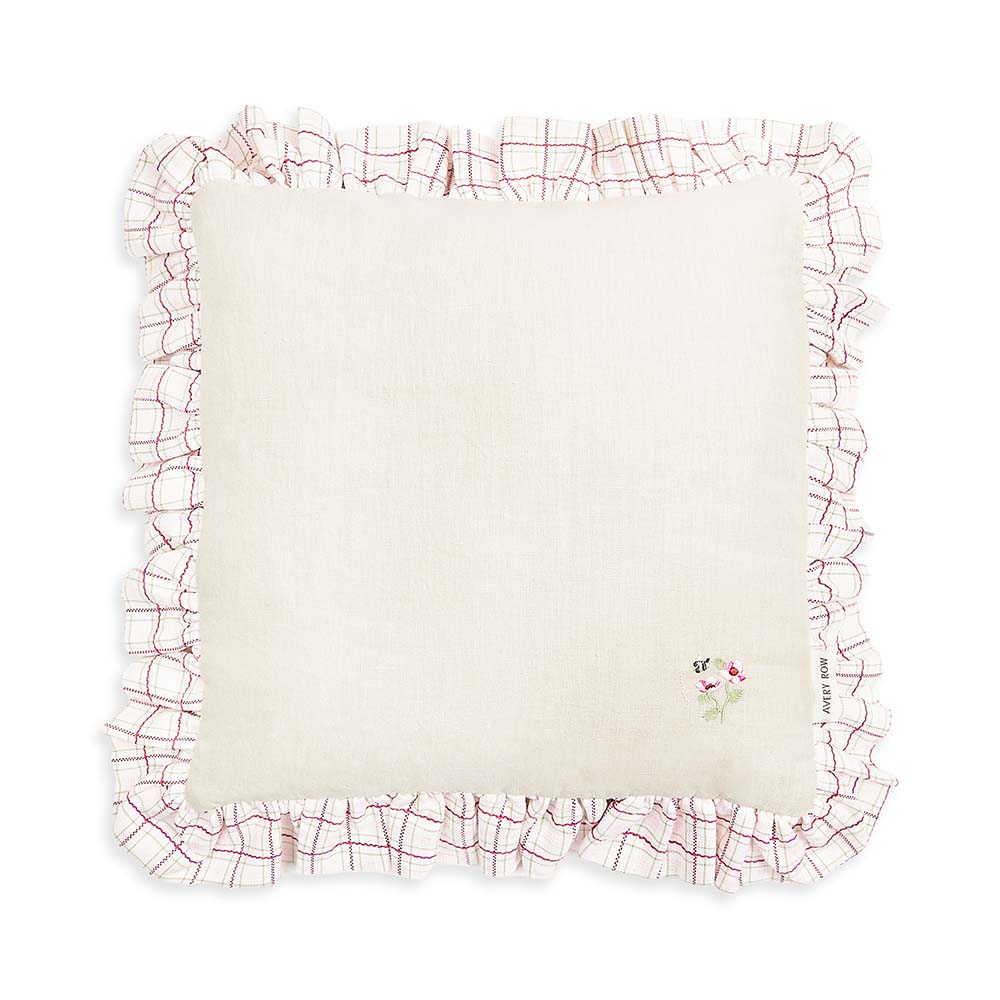 White pillow with red floral border on a white background