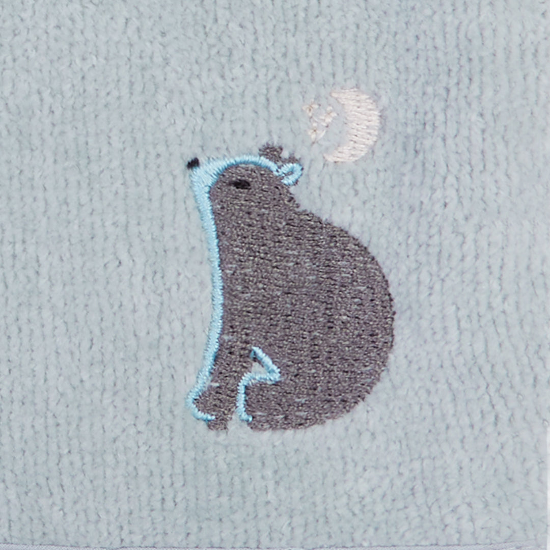Embroidered hedgehog design on a textured fabric background