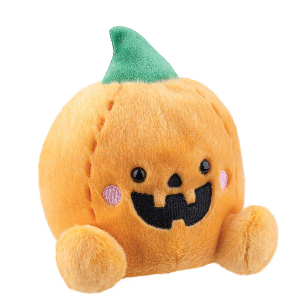 Plush toy pumpkin with a green hat on a white background