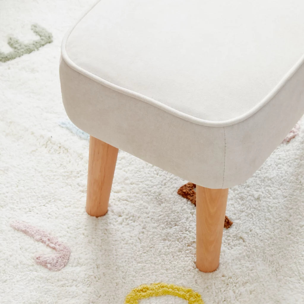 White stool with wooden legs on a light-colored rug