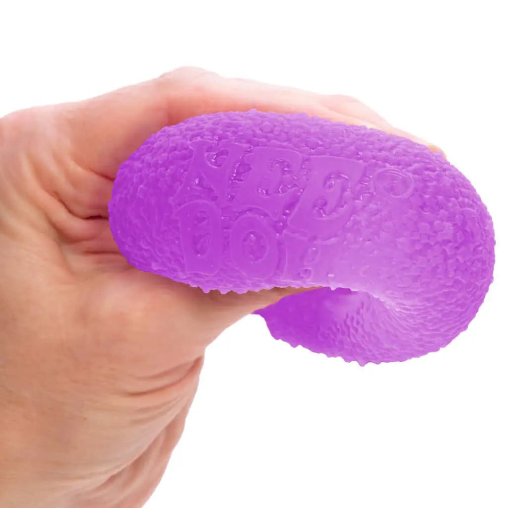 Hand holding a purple stress ball against a white background