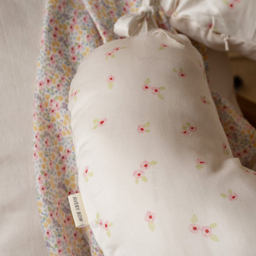 Floral-patterned fabric with a visible brand tag on a neutral background