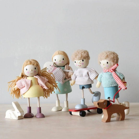 Set of wooden dolls with a dog on a neutral background