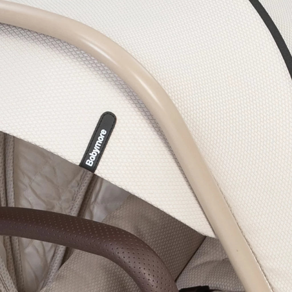 Close-up of a baby carrier with 'Babymoov' branding on a white background