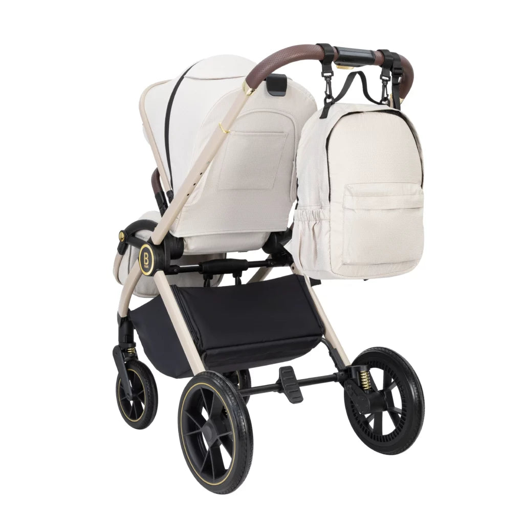 White baby stroller with matching backpack on a white background