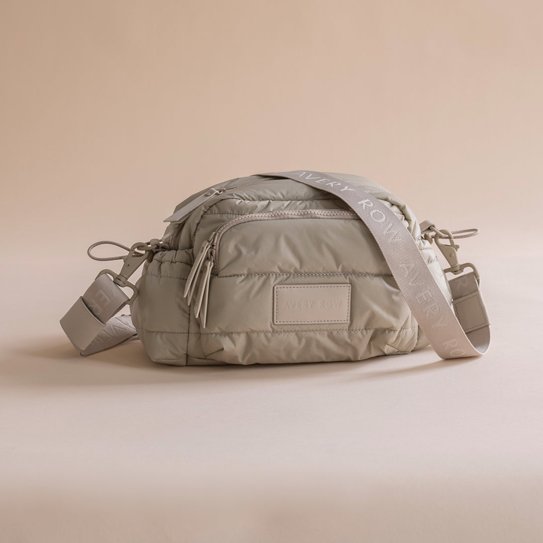 Gray quilted bag with a visible brand logo on a beige background