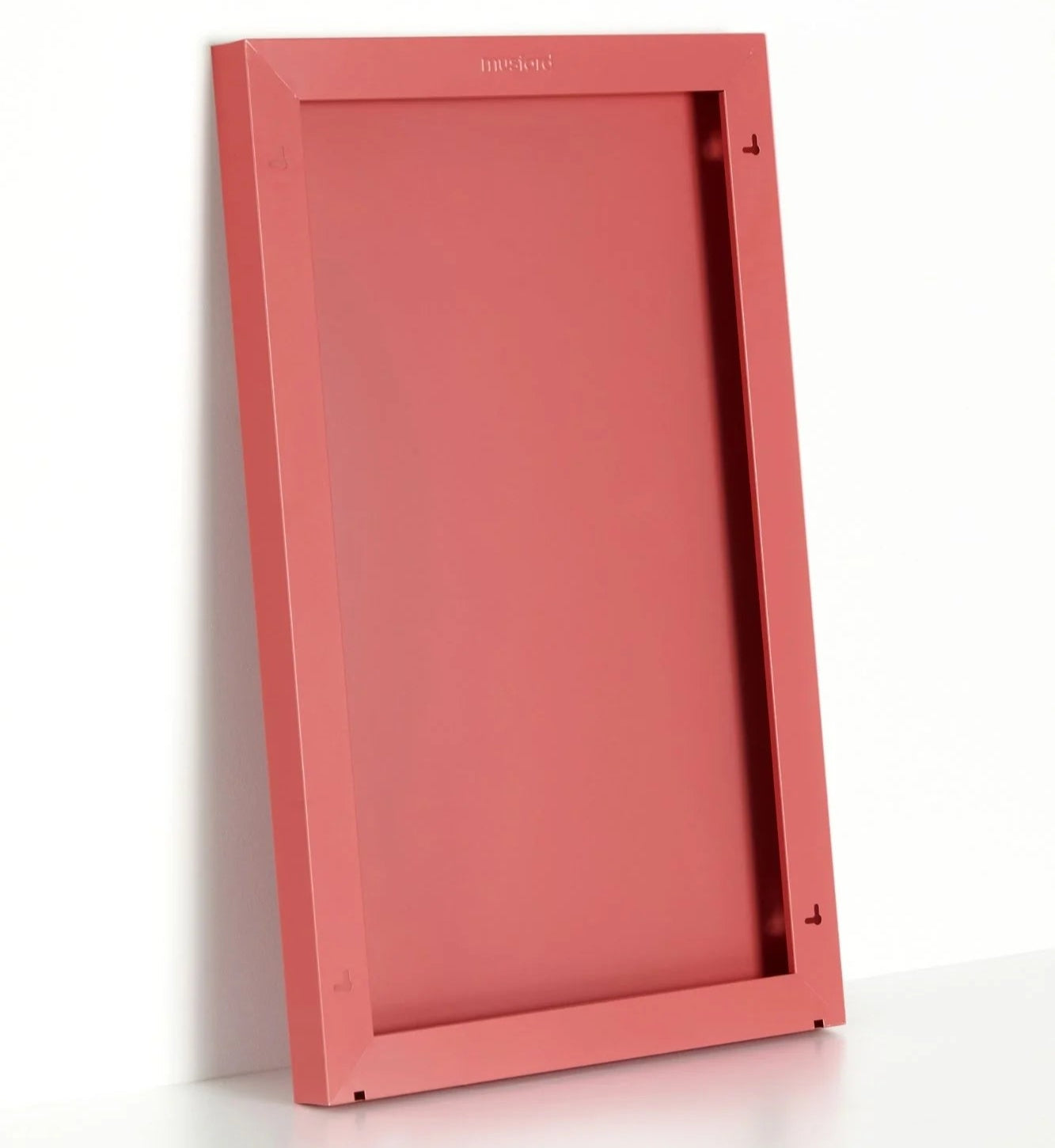 Red rectangular object with a textured surface on a white background