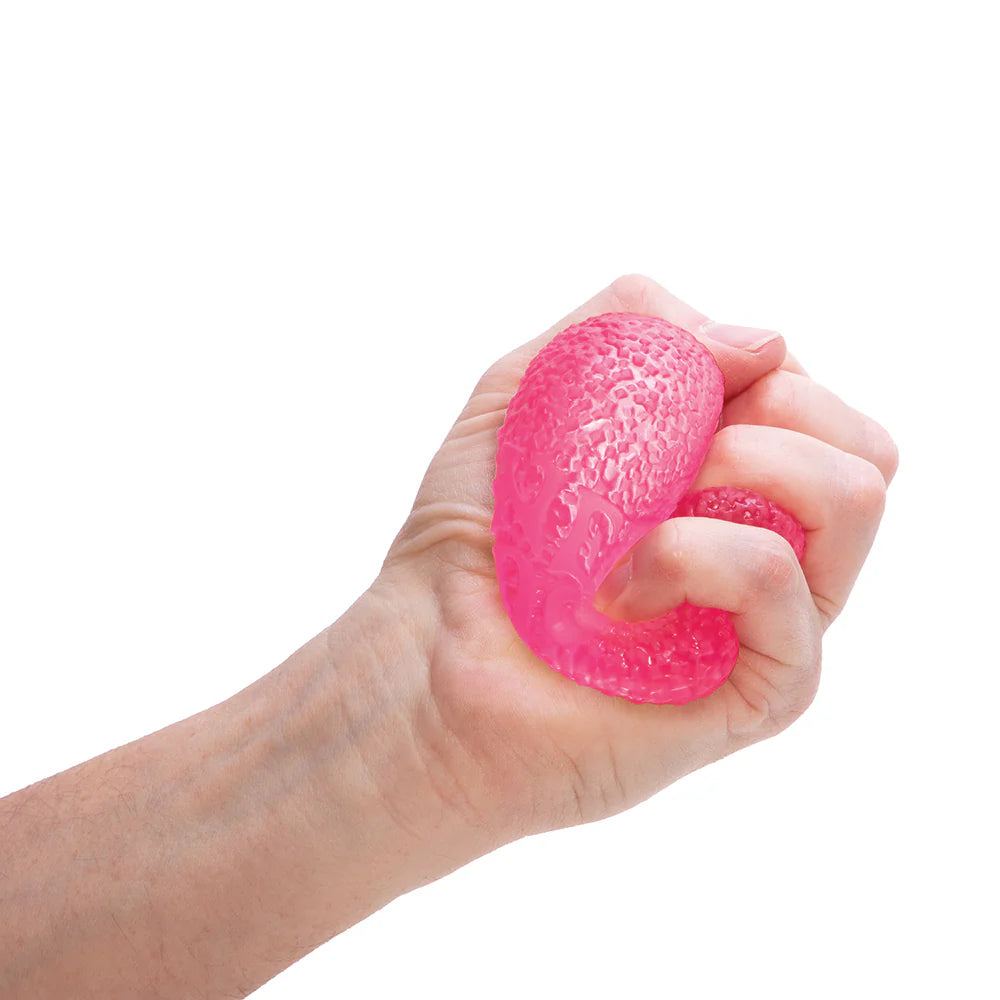 Hand holding a pink textured stress ball against a white background