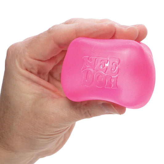 Hand holding a pink bar of soap with 'KISSES' branding on a white background