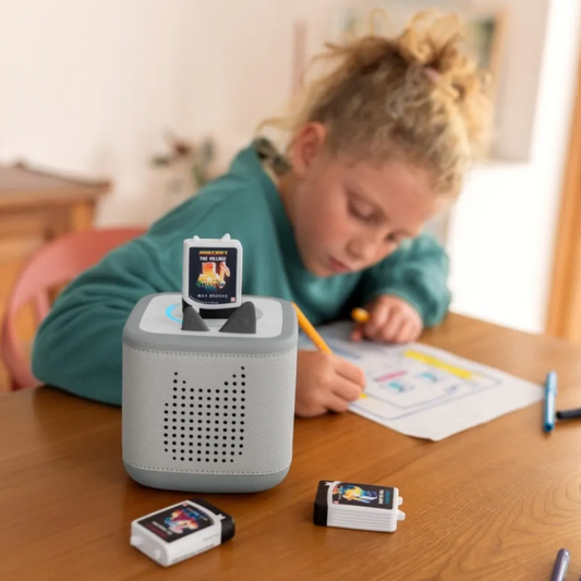 Child using a educational device on a table with colorful screens