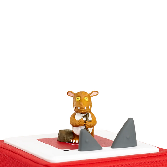 Toy figure of a character with a red base and shark fins on a white background