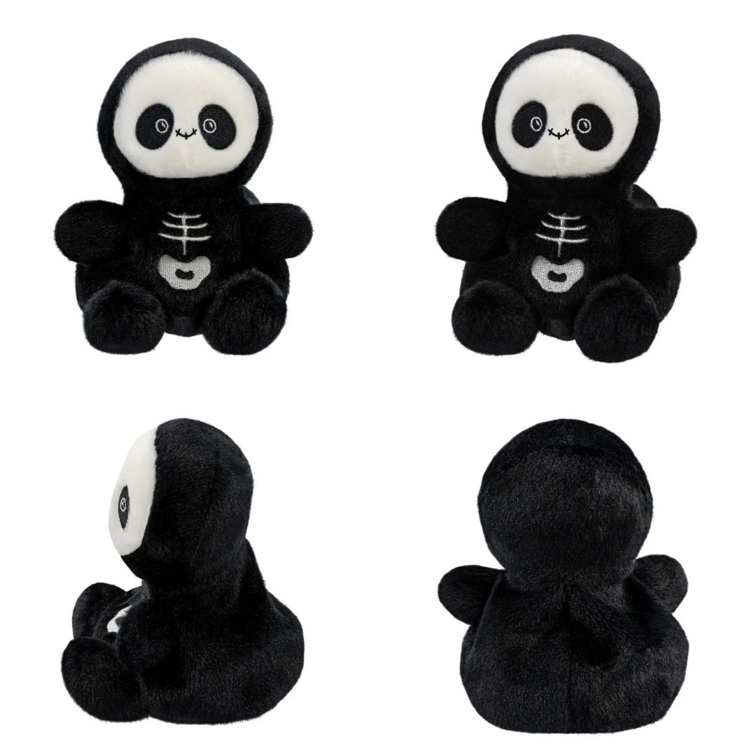 Set of four black and white skeleton plush toys on a white background