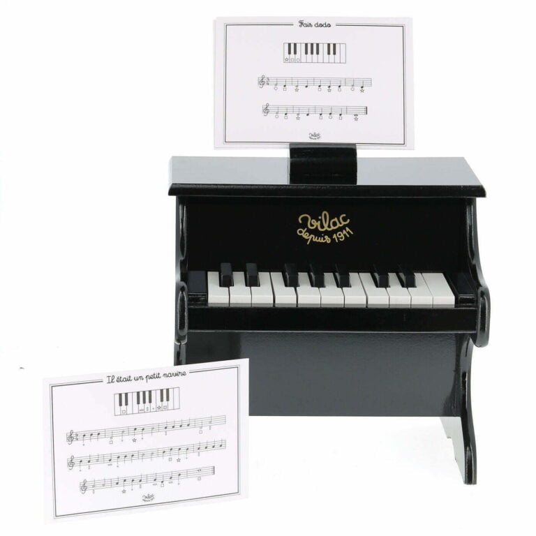 Toy piano with music stand on a white background
