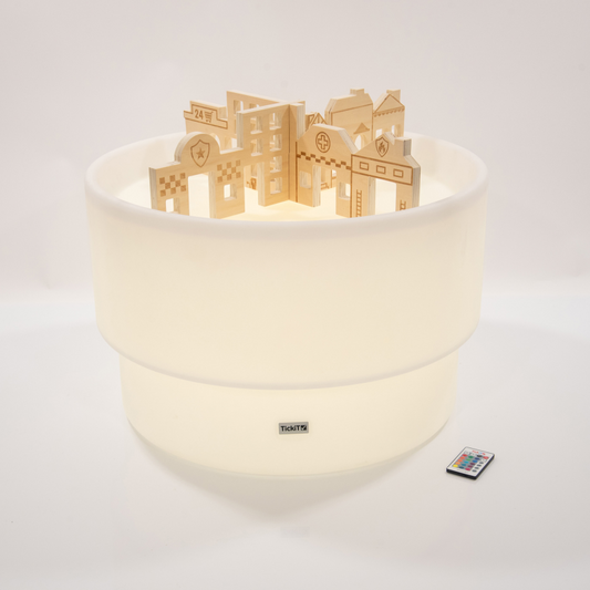 Sensory mood table with wooden dividers in the style of buildings. table glowing pale yellow