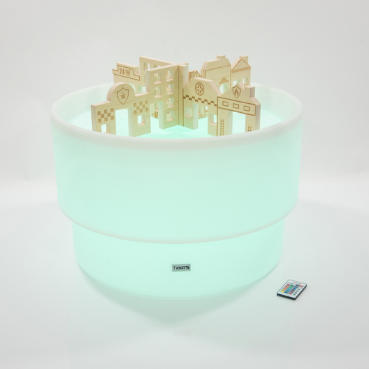 Sensory mood table with wooden dividers in the style of buildings. Glowing Green