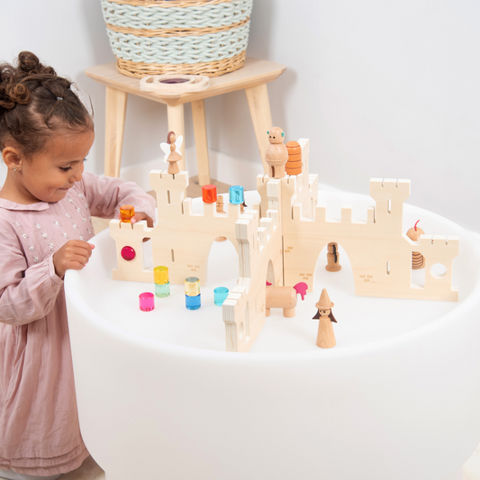 Child playing with a castle set up on a discovery sensory table