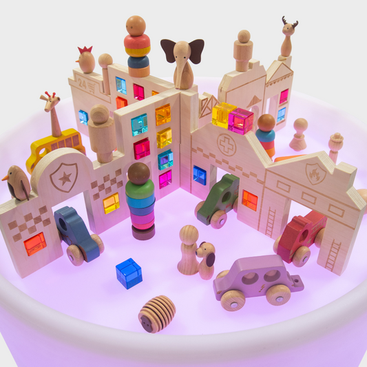 Colourful wooden toy set with buildings, animals, and vehicles on a white background