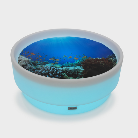 Sensory low mood table glowing blue with an under the sea mat
