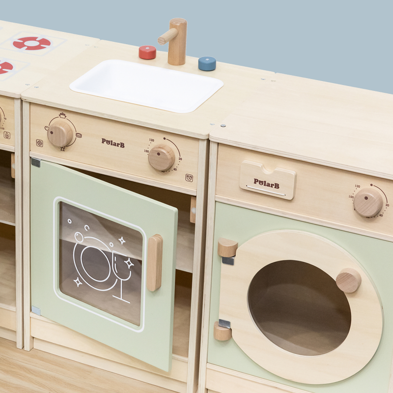 Wooden toy kitchen set with oven and washing machine on a light blue background