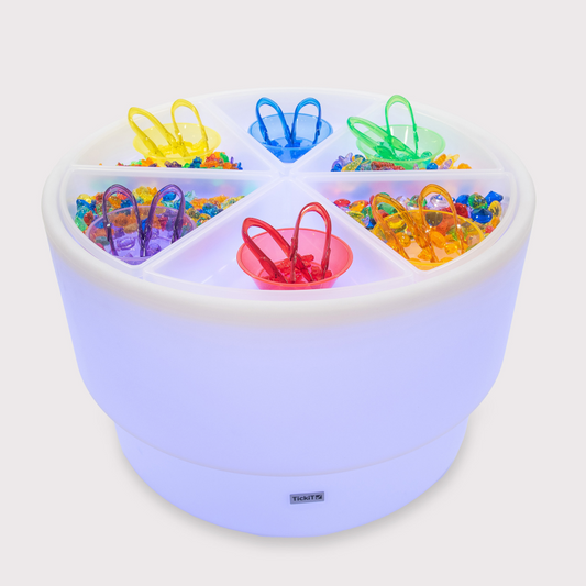 Colourful sensory mood table with various toys on a white background