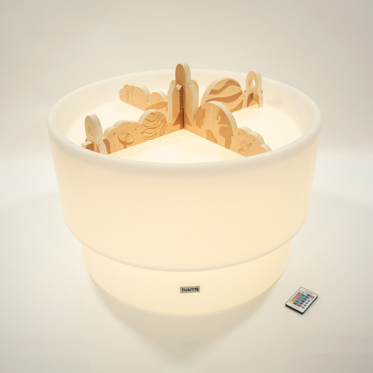 Round light table with wooden dividers in a space and planet print.