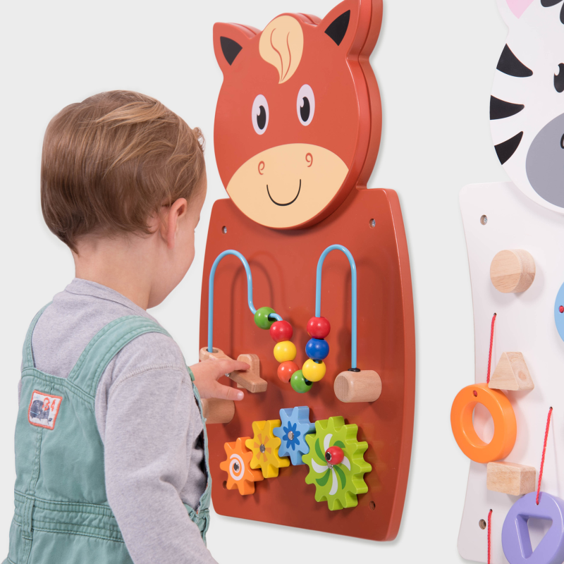 Child playing with a horse-shaped educational toy on a white background