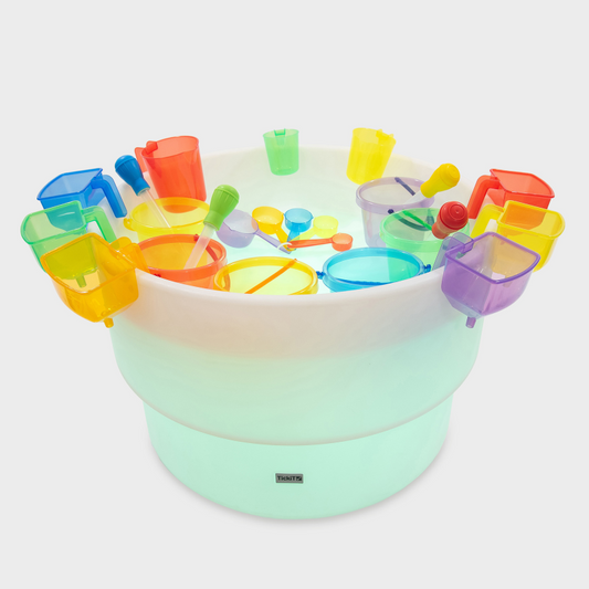 Colorful sand toys arranged around a sensory mood table on a white background