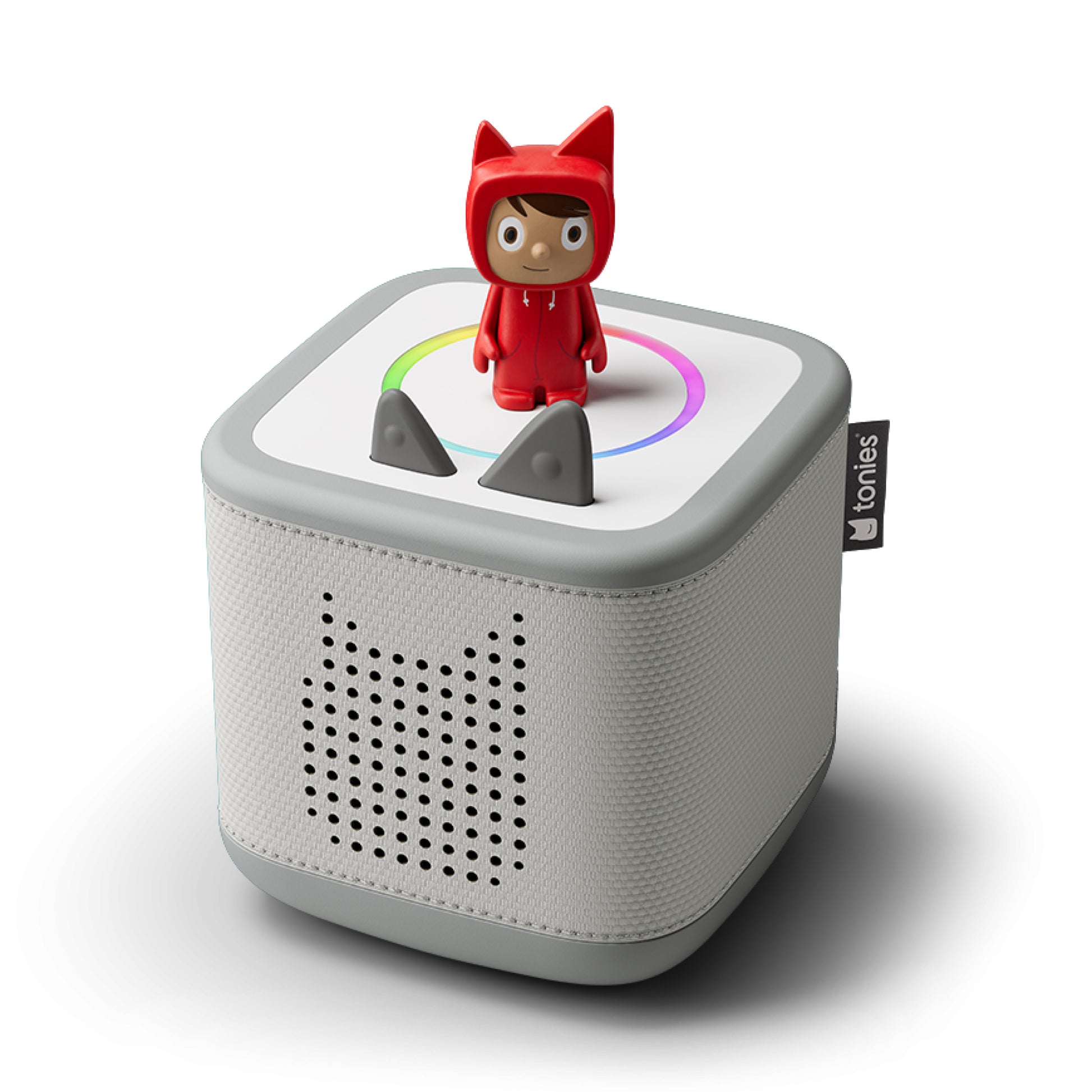 White electronic device with a small red character on top, featuring the brand 'tonies'.
