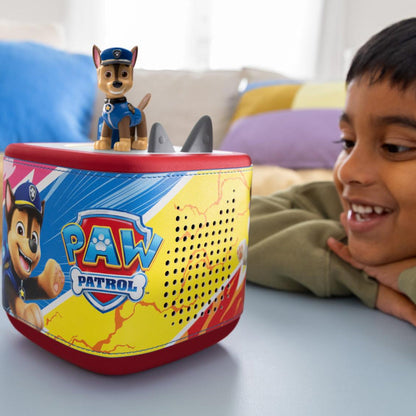 Child playing with a PAW Patrol toy on a table
