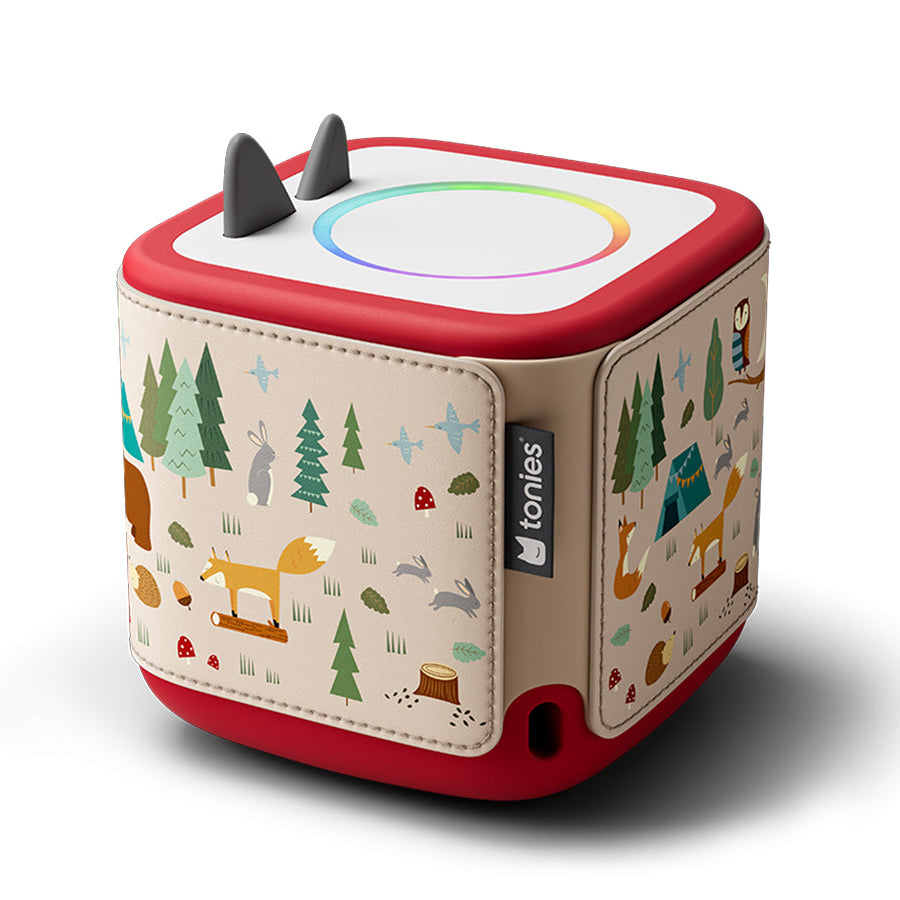 Children's toy with a forest design and red top on a white background