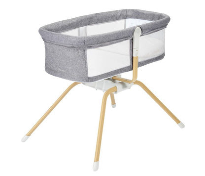 Baby bassinet with gray fabric and wooden legs on a white background