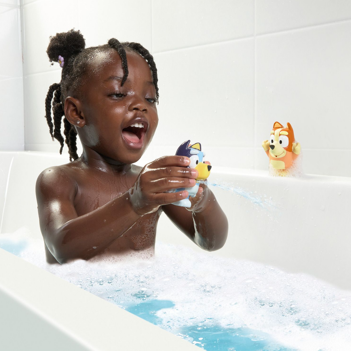 Child playing with bath toys in a bathtub