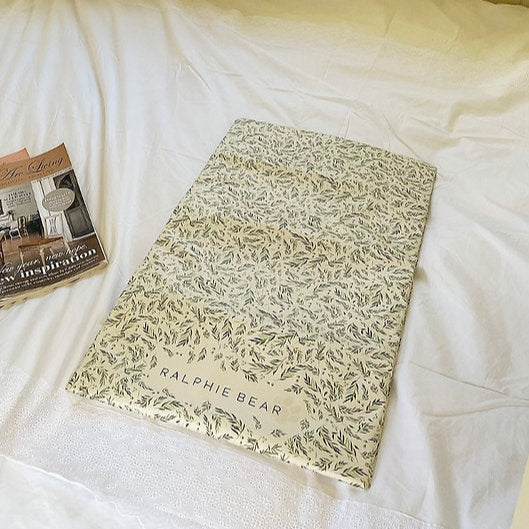Floral-patterned notebook with 'Ralphie Bear' branding on a white surface