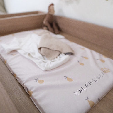 Baby crib with a blanket and toy, featuring the brand 'Ralphie Bear'.