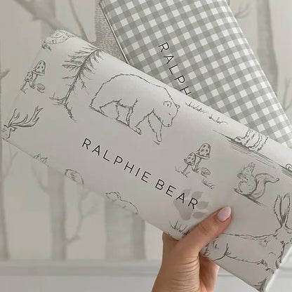 Two children's pillows with 'Ralphie Bear' branding and illustrations on a neutral background.