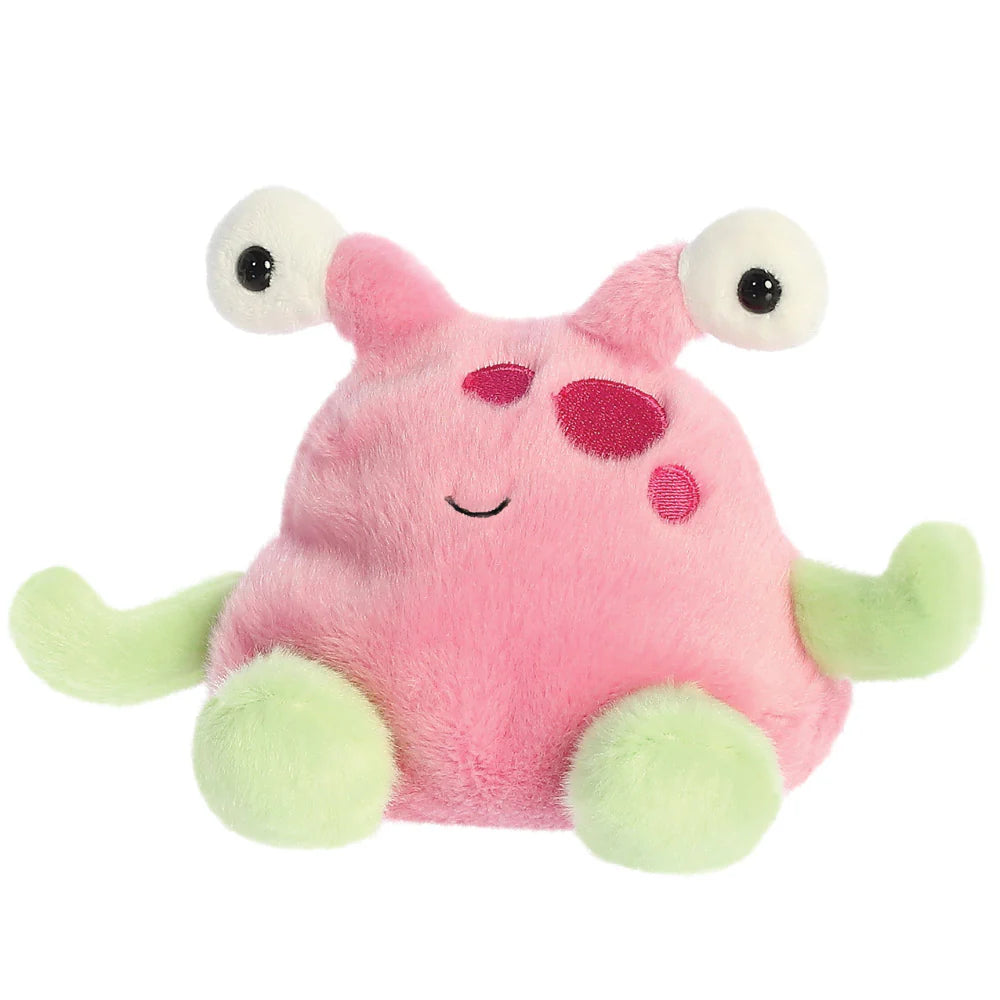 Pink plush toy with googly eyes and green feet on a white background